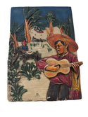 Plaque of a Man Playing a Guitar