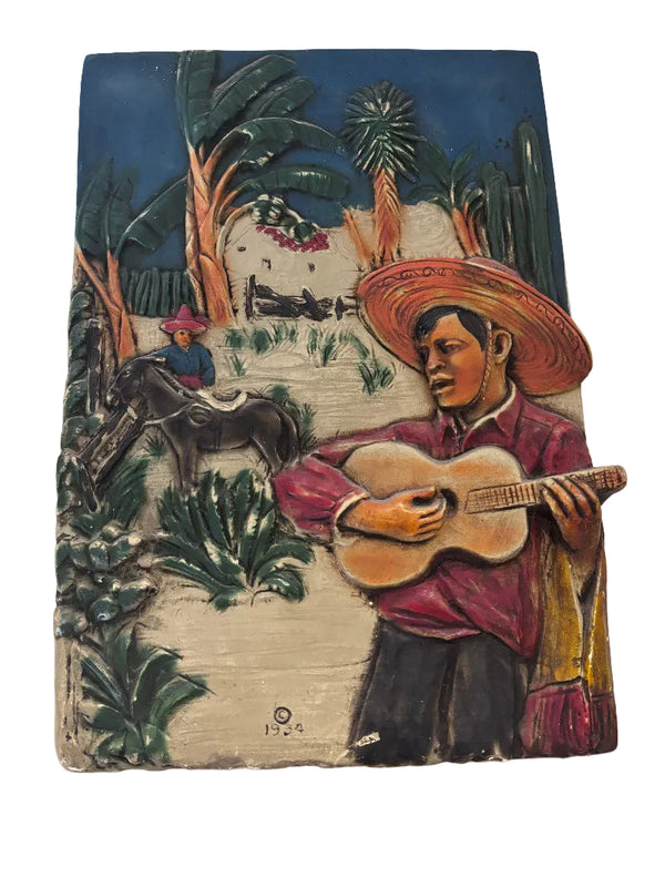 Plaque of a Man Playing a Guitar