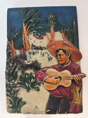 Plaque of a Man Playing a Guitar
