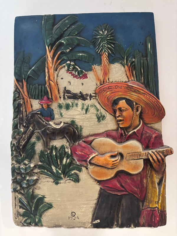 Plaque of a Man Playing a Guitar